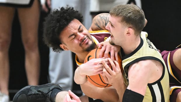 Minnesota guard Braeden Carrington (4) and Purdue guard Braden Smith (3) force a jump ball during the second half at Mackey Arena in West Lafayette, Ind., on Feb. 15, 2024.