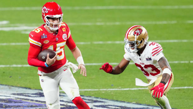 Chiefs quarterback Patrick Mahomes, left, carries the ball while being pursued by 49ers safety Logan Ryan