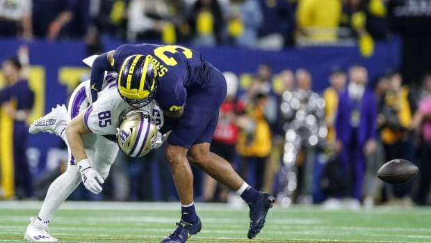 Michigan defensive back Keon Sabb tackles Washington tight end Josh Cuevas during the second half of U-M's 34-13 win in the College Football Playoff national championship game in Houston on Monday, Jan. 8, 2024.