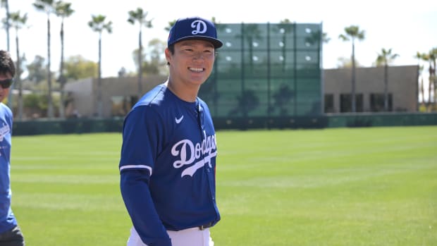 Feb 19, 2024; Glendale, AZ, USA; Los Angeles Dodgers starting pitcher Yoshinobu Yamamoto (18) walks on the field during spring training at Camelback Ranch.