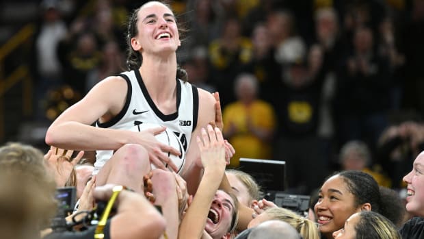 Feb 15, 2024; Iowa City, Iowa, USA; Iowa Hawkeyes guard Caitlin Clark (22) reacts with teammates after the game. Clark broke the NCAA women's all-time scoring record against the Michigan Wolverines at Carver-Hawkeye Arena.