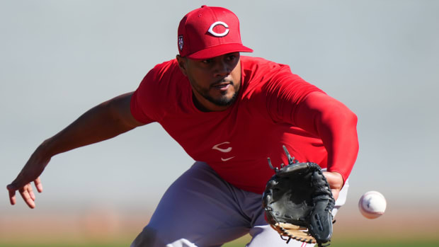 Cincinnati Reds infielder Jeimer Candelario fields a groundball at third base during spring training workouts, Monday, Feb. 19, 2024, at the team's spring training facility in Goodyear, Ariz. 