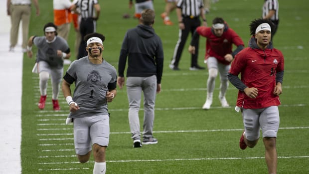 Jan 1, 2021; New Orleans, LA, USA; Ohio State Buckeyes quarterback Justin Fields (1) and quarterback C.J. Stroud (14) warm up prior to the College Football Playoff semifinal against the Clemson Tigers at the Allstate Sugar Bowl in the Mercedes-Benz Superdome in New Orleans on Friday, Jan. 1, 2021.