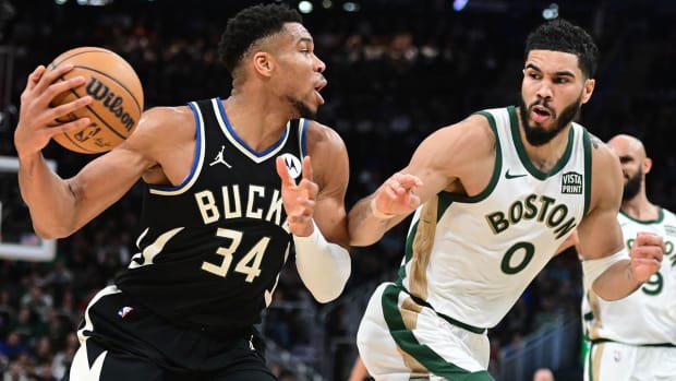 Jayson Tatum guards Giannis Antetokounmpo in a Bucks-Celtics clash.