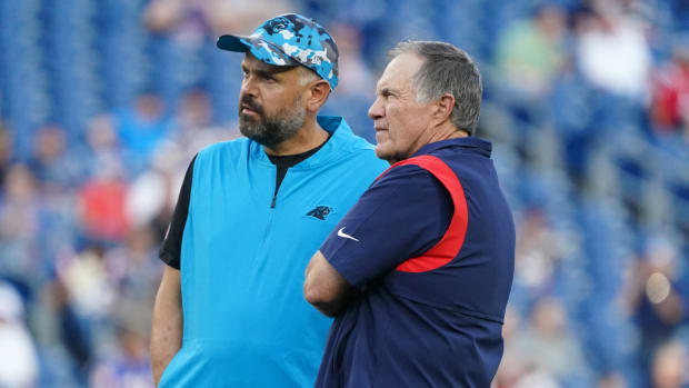 Carolina Panthers coach Matt Rhule chats with New England Patriots coach Bill Belichick.