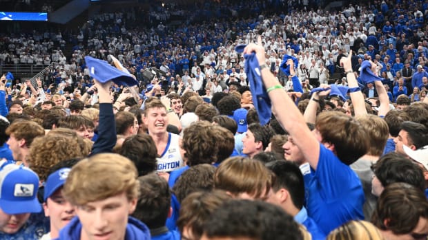 Creighton fans rush the court after beating UConn
