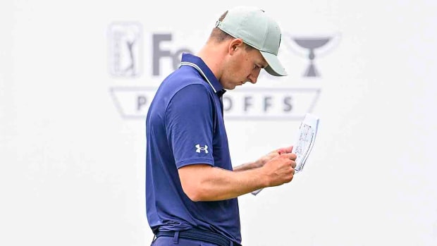Jordan Spieth marks his scorecard during the first round of the 2023 FedEx St. Jude Championship at TPC Southwind in Memphis, Tenn.
