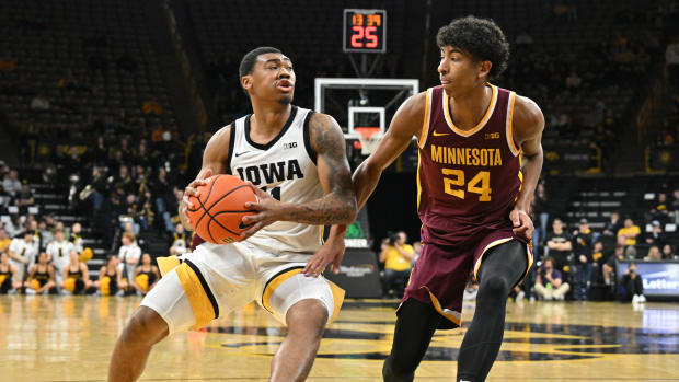 Feb 11, 2024; Iowa City, Iowa, USA; Iowa Hawkeyes guard Tony Perkins (11) goes to the basket as Minnesota Golden Gophers guard Cam Christie (24) defends during the second half at Carver-Hawkeye Arena.