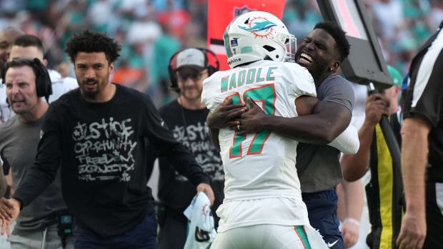 Miami Dolphins wide receiver Tyreek Hill, right, hugs Miami Dolphins wide receiver Jaylen Waddle (17) after scoring a touchdown against the New York Jets during the first half of an NFL game at Hard Rock Stadium in Miami Gardens.