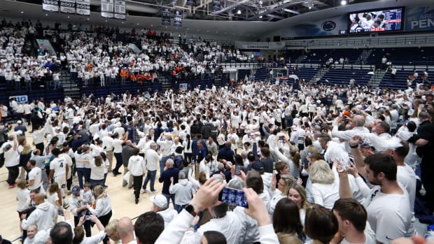 Penn State basketball fans storm the court at Rec Hall after the Nittany Lions defeat No. 12 Illinois in a Big Ten basketball game.