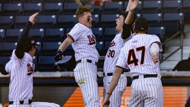 Harrison Didawick celebrates with his teammates after hitting a home run during the Virginia baseball game against Old Dominion at Disharoon Park.