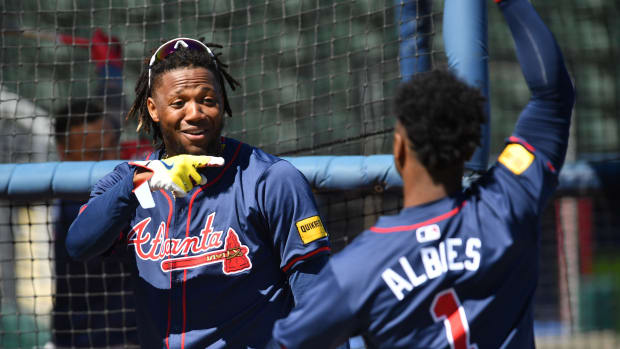 Atlanta Braves players Ronald Acuna, Jr. (#13), left, and Ozzie Albies (#1) joke around during batting practice Tuesday, Feb. 20, 2024 at CoolToday Park in North Port, Florida.  