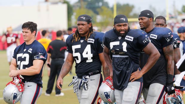 Aug 4, 2014; Richmond, VA, USA; New England Patriots linebacker James Morris (52), Patriots outside linebacker Dont'a Hightower (54), and Patriots outside linebacker Jerod Mayo (51) leave the field after joint practice with the New England Patriots on day ten of training camp at the Bon Secours Washington Redskins Training Center.