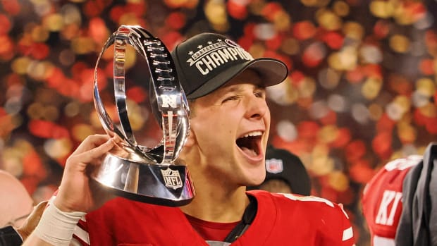 Jan 28, 2024; Santa Clara, California, USA; San Francisco 49ers quarterback Brock Purdy (13) holds the George Halas Trophy while after winning the NFC Championship football game against the Detroit Lions at Levi's Stadium. Mandatory Credit: Kelley L Cox-USA TODAY Sports  