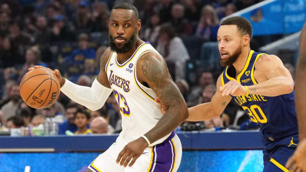 Los Angeles Lakers forward LeBron James (23) dribbles against Golden State Warriors guard Stephen Curry (30) during the first quarter at Chase Center in San Francisco, California, on Jan. 27, 2024.