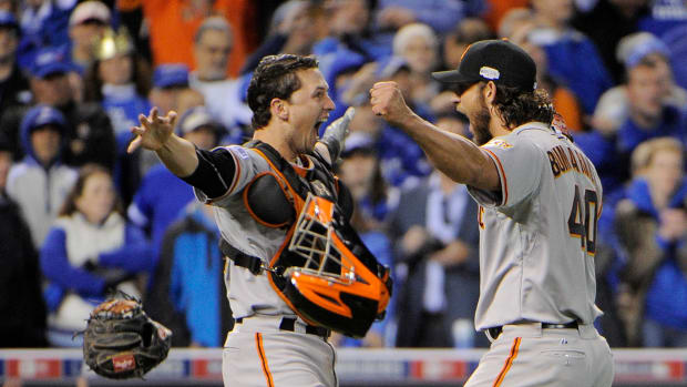 Buster Posey and Madison Bumgarner celebrate defeating the Kansas City Royals.