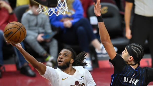 Feb 22, 2024; Cleveland, Ohio, USA; Cleveland Cavaliers guard Darius Garland (10) lays up a shot beside Orlando Magic guard Anthony Black (0) in the third quarter at Rocket Mortgage FieldHouse.