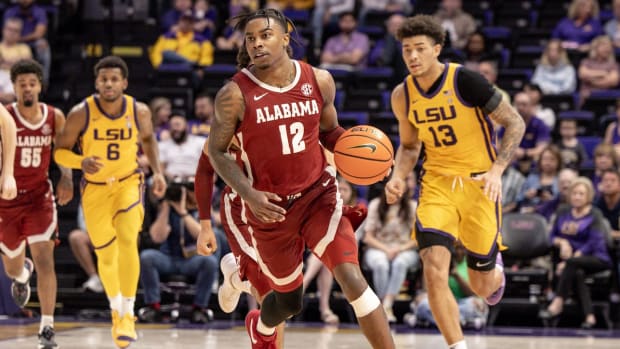 Alabama Crimson Tide guard Latrell Wrightsell Jr. (12) brings the ball up court against LSU Tigers forward Jalen Reed (13) during the second half at Pete Maravich Assembly Center in Baton Rouge, Louisiana, on Feb. 10, 2024.