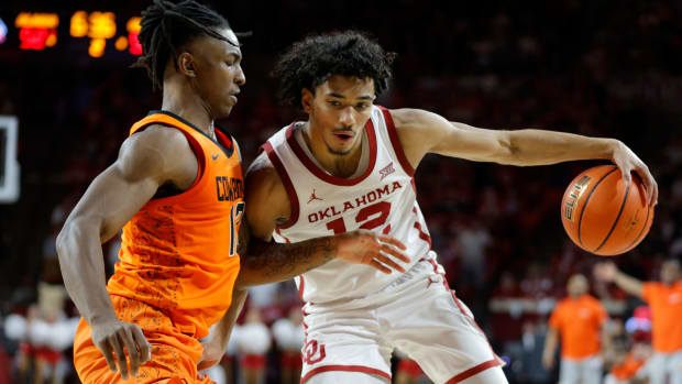 Oklahoma Sooners guard Milos Uzan (12) tries to get past Oklahoma State Cowboys guard Javon Small (12) during a Bedlam college basketball game between the University of Oklahoma Sooners (OU) and the Oklahoma State Cowboys (OSU) at Lloyd Noble Center in Norman, Okla., Saturday, Feb. 10, 2024. Oklahoma won 66-62.