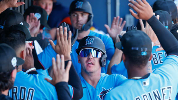 Feb 27, 2023; West Palm Beach, Florida, USA; Miami Marlins center fielder Peyton Burdick (6) gets high fives from teammates after hitting a home run during the second inning against the Houston Astros at The Ballpark of the Palm Beaches.