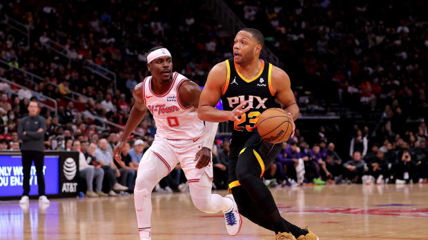Dec 27, 2023; Houston, Texas, USA; Phoenix Suns guard Eric Gordon (23) drives to the basket against Houston Rockets guard Aaron Holiday (0) during the game at Toyota Center. Mandatory Credit: Erik Williams-USA TODAY Sports