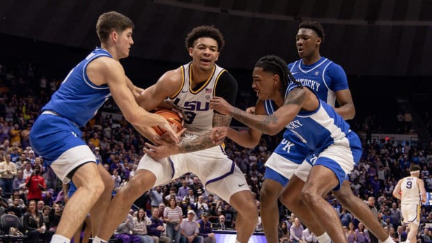 Feb 21, 2024; Baton Rouge, Louisiana, USA; LSU Tigers forward Jalen Reed (13) secures a rebound from Kentucky Wildcats guard Rob Dillingham (0) during the second half of the game at Pete Maravich Assembly Center. Mandatory Credit: Stephen Lew-USA TODAY Sports