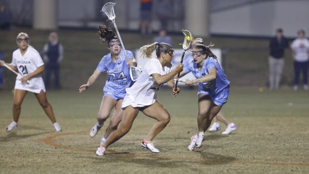 Kiki Shaw dodges with the ball during the Virginia women's lacrosse game against North Carolina at Klockner Stadium.