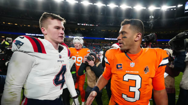 Dec 24, 2023; Denver, Colorado, USA; New England Patriots quarterback Bailey Zappe (4) and Denver Broncos quarterback Russell Wilson (3) following the game at Empower Field at Mile High. Mandatory Credit: Ron Chenoy-USA TODAY Sports