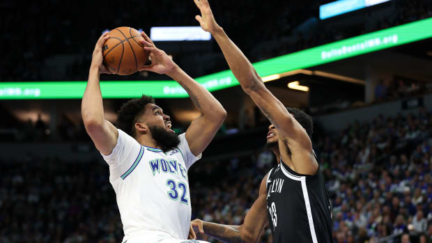 Minnesota Timberwolves center Karl-Anthony Towns (32) shoots as Brooklyn Nets center Nic Claxton (33) defends during the first half at Target Center in Minneapolis on Feb. 24, 2024.