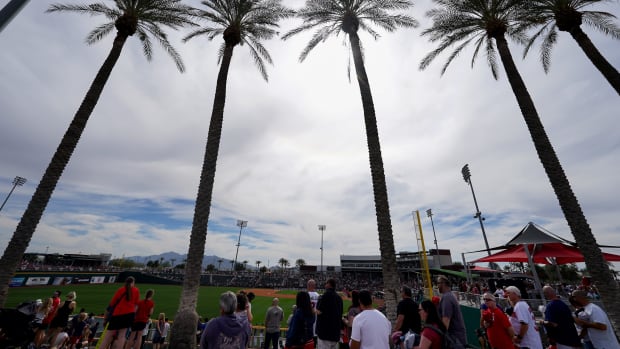 Baseball fans walk the concourse of Goodyear Ballpark before the the inning during a MLB spring training baseball game between the Cleveland Guardians and the Cincinnati Reds, Saturday, Feb. 24, 2024, at Goodyear Ballpark in Goodyear, Ariz.