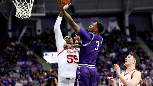 Feb 24, 2024; Fort Worth, Texas, USA; TCU Horned Frogs guard Avery Anderson III (3) shoots as Cincinnati Bearcats forward Aziz Bandaogo (55) defends during the first half at Ed and Rae Schollmaier Arena. Mandatory Credit: Kevin Jairaj-USA TODAY Sports