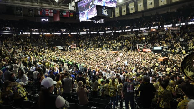 Wake Forest Demon Deacons students storm the court after Wake Forest beat the Duke Blue Devils at Lawrence Joel Veterans Memorial Coliseum in Winston-Salem, North Carolina, on Feb. 24, 2024.