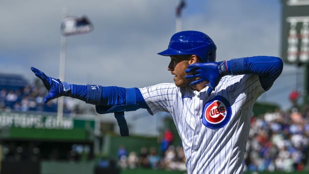 Aug 30, 2023; Chicago, Illinois, USA; Chicago Cubs center fielder Cody Bellinger (24) signals after he hits an RBI single against the Milwaukee Brewers during the eighth inning at Wrigley Field.
