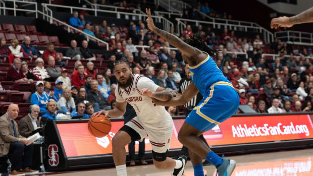 Feb 7, 2024; Stanford, California, USA; Stanford Cardinal guard Jared Bynum (1) drives the ball around UCLA Bruins guard Dylan Andrews (2) during the first half at Maples Pavilion. Mandatory Credit: Stan Szeto-USA TODAY Sports