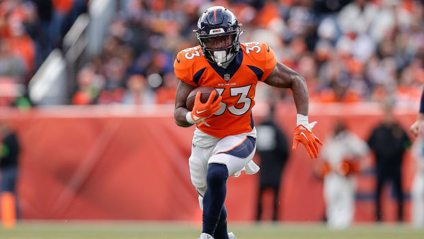 Dec 31, 2023; Denver, Colorado, USA; Denver Broncos running back Javonte Williams (33) runs the ball in the first quarter against the Los Angeles Chargers at Empower Field at Mile High. Mandatory Credit: Isaiah J. Downing-USA TODAY Sports