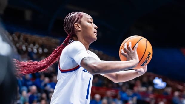 Kansas Jayhawks center Taiyanna Jackson passes the ball during a game against the Houston Cougars.