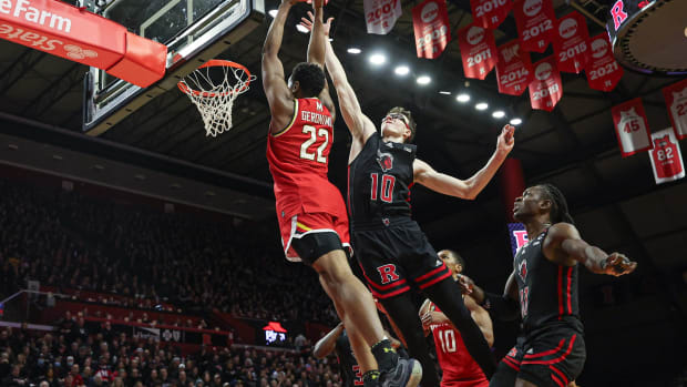 Maryland Terrapins forward Jordan Geronimo (22) drives for a shot against Rutgers Scarlet Knights guard Gavin Griffiths (10) and center Clifford Omoruyi (11) during the first half at Jersey Mike's Arena.