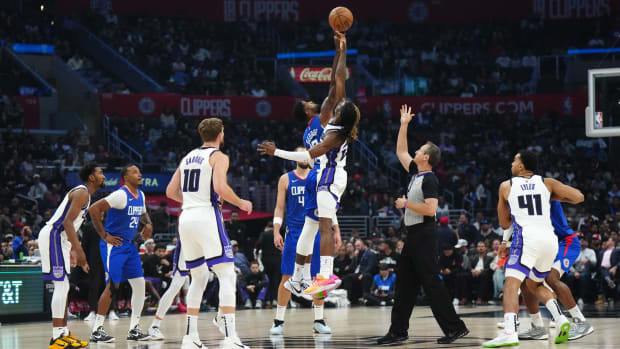 Dec 6, 2023; Los Angeles, California, USA; A jump ball between LA Clippers forward Paul George (13) and Sacramento Kings guard Keon Ellis (23) in the first half at Crypto.com Arena. Mandatory Credit: Kirby Lee-USA TODAY Sports