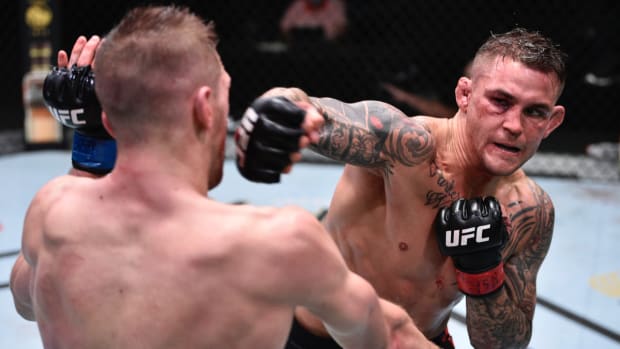 June 27, 2020; Las Vegas, NV, USA; Dustin Poirier (red gloves) punches Dan Hooker of New Zealand (blue gloves) during UFC Fight Night at the UFC APEX. Mandatory Credit: Chris Unger/Zuffa LLC via USA TODAY Sports