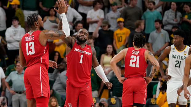Feb 24, 2024; Waco, Texas, USA; Houston Cougars forward J'Wan Roberts (13) and guard Jamal Shead (1) high five in the closing moments of overtime against the Baylor Bears at Paul and Alejandra Foster Pavilion. Mandatory Credit: Raymond Carlin III-USA TODAY Sports