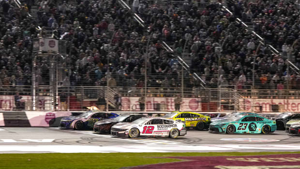 Three cars cross the finish line nearly simultaneously at a NASCAR race