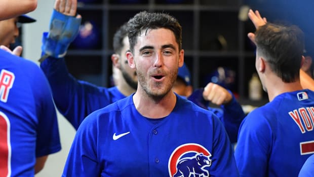 Cubs centerfielder Cody Bellinger celebrates his teammate scoring in a game.