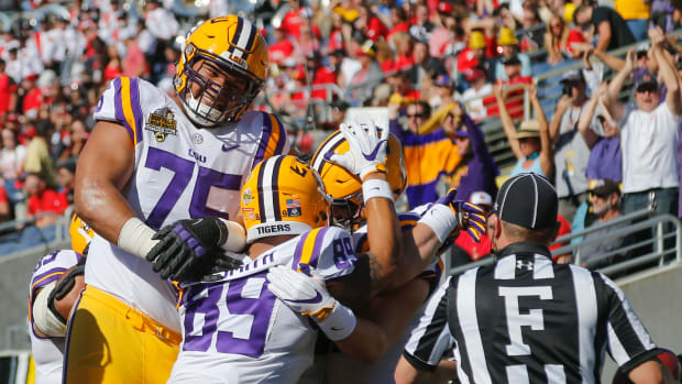 Dec 31, 2016; Orlando, FL, USA; LSU Tigers guard Maea Teuhema (75) and tight end DeSean Smith (89) celebrate a touchdown with tight end Colin Jeter (81) during the second quarter of an NCAA football game in the Buffalo Wild Wings Citrus Bowl at Camping World Stadium. Mandatory Credit: Reinhold Matay-USA TODAY Sports  