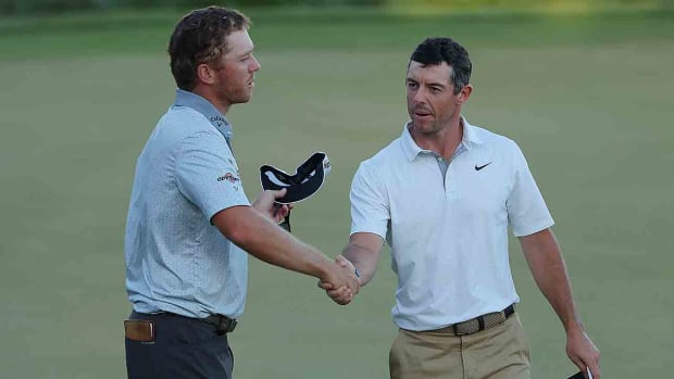Talor Gooch (left) and Rory McIlroy shake hands on the 18th green after their round at the 2022 Arnold Palmer Invitational presented by Mastercard at Bay Hill Golf Course in Orlando, Fla.