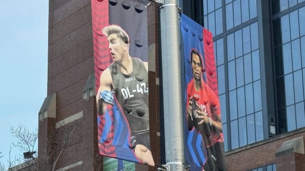 Lukas Van Ness and C.J. Stroud are shown on banners outside Lucas Oil Stadium