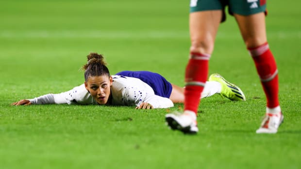 Trinity Rodman face down on the pitch during a game against Mexico