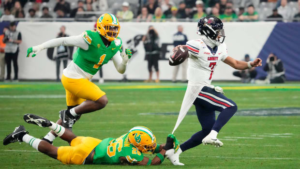 Oregon linebacker Devon Jackson chases Liberty quarterback Kaidon Salter during the No. 8 Ducks’ 45-6 win over the No. 18 Flames in the Fiesta Bowl on Jan. 1, 2024.