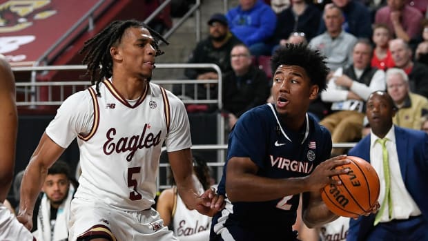 Virginia Cavaliers guard Reece Beekman (2) and Boston College Eagles guard DeMarr Langford Jr. (5) during the first half at Conte Forum.