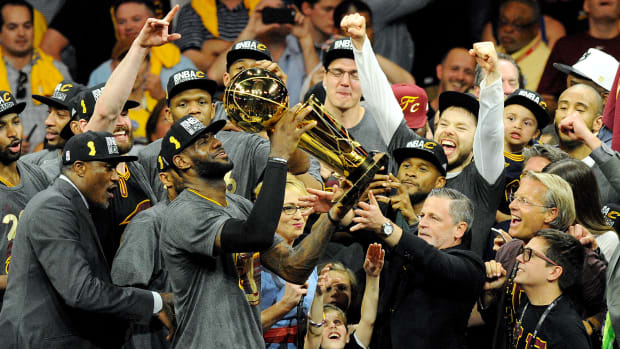 Jun 19, 2016; Oakland, CA, USA; Cleveland Cavaliers forward LeBron James (23) celebratew with the Larry O'Brien Championship Trophy after beating the Golden State Warriors in game seven of the NBA Finals at Oracle Arena. Mandatory Credit: Gary A. Vasquez-USA TODAY Sports  