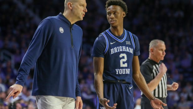 Feb 24, 2024; Manhattan, Kansas, USA; Brigham Young Cougars head coach Mark Pope talks to guard Jaxson Robinson (2) during a break in first-half action against the Kansas State Wildcats at Bramlage Coliseum. Mandatory Credit: Scott Sewell-USA TODAY Sports  